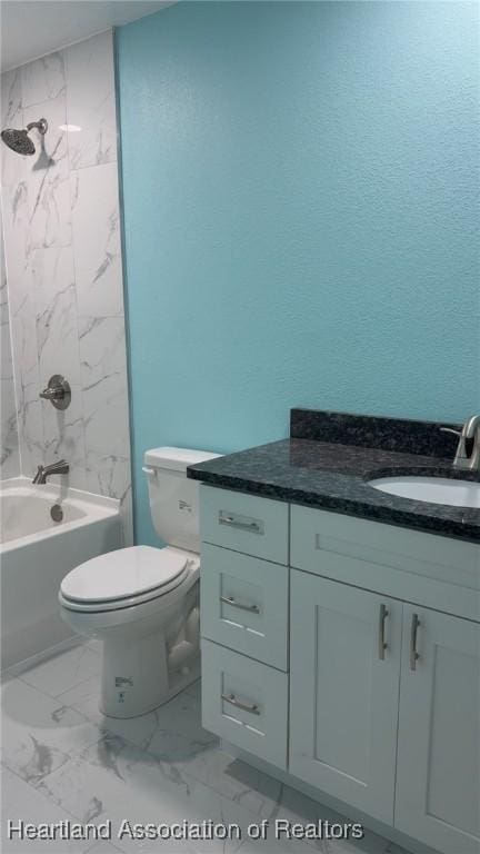 bathroom featuring marble finish floor, bathtub / shower combination, toilet, and vanity