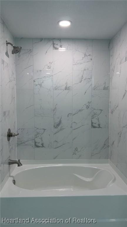 bathroom featuring recessed lighting and shower / bathtub combination