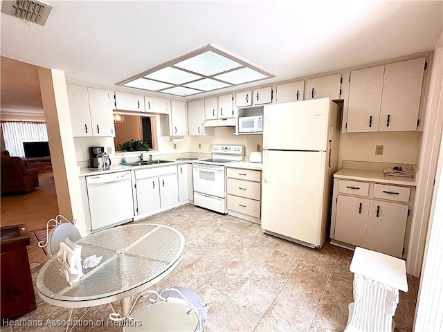 4620 Lafayette Ave, Sebring, FL 33875 - kitchen featuring light countertops, a sink, white appliances, and visible vents