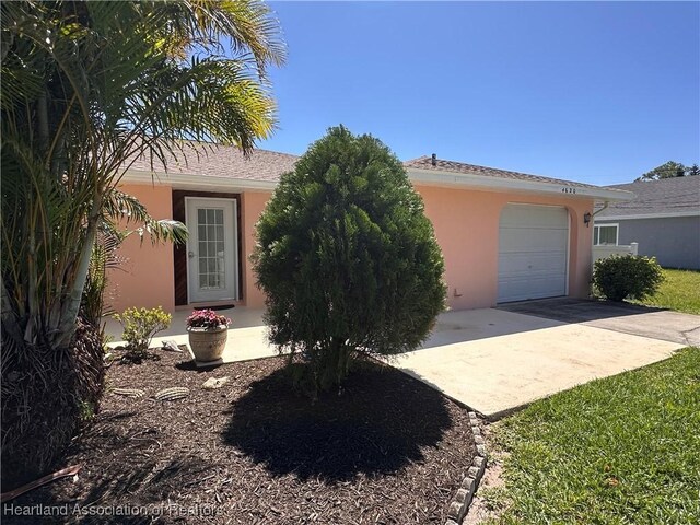 4620 Lafayette Ave, Sebring, FL 33875 - view of front of home with concrete driveway, an attached garage, and stucco siding