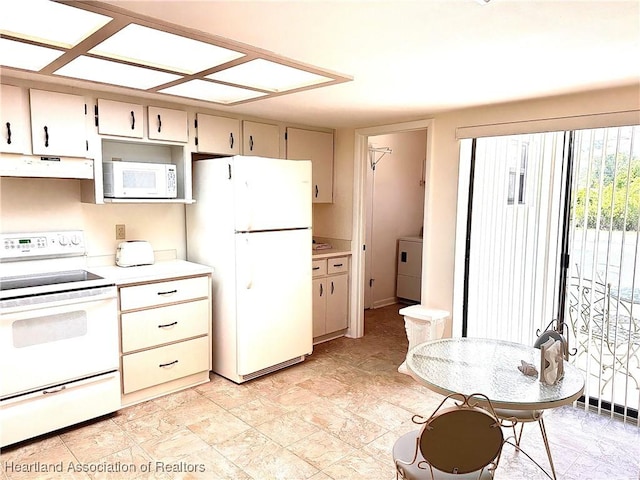 4620 Lafayette Ave, Sebring, FL 33875 - kitchen with under cabinet range hood, white appliances, light countertops, and washer / clothes dryer