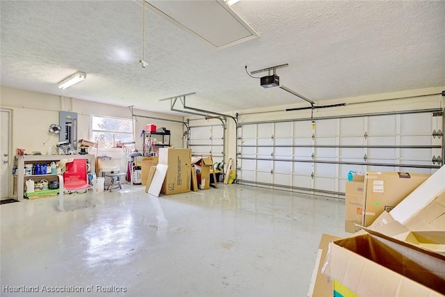 garage featuring electric panel and a garage door opener