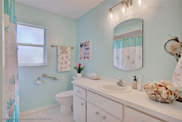 bathroom featuring toilet, vanity, and tile patterned floors