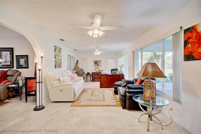 tiled living room featuring ceiling fan