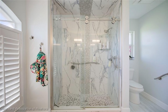 bathroom featuring toilet and walk in shower