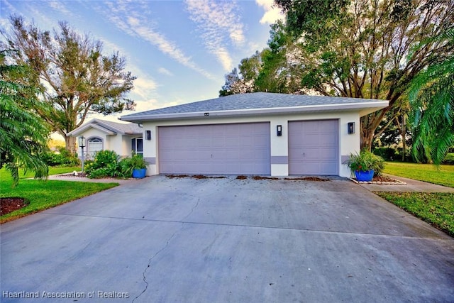 single story home featuring a front lawn and a garage