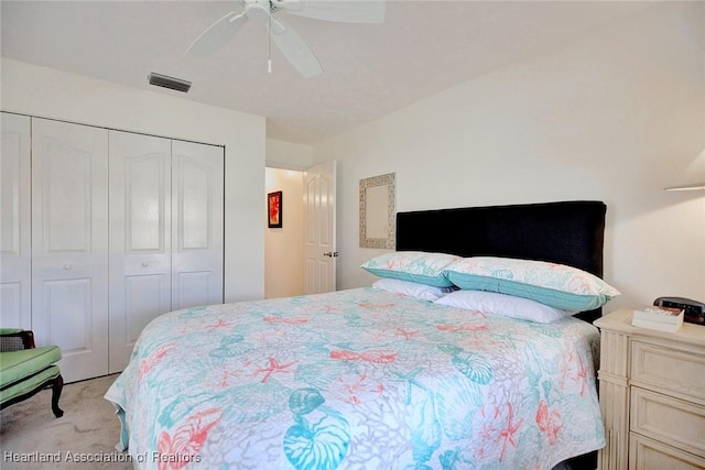 bedroom featuring ceiling fan, a closet, and light carpet