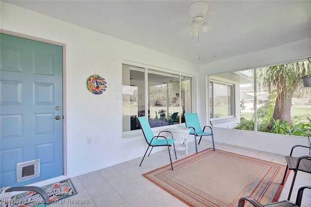 sunroom featuring ceiling fan