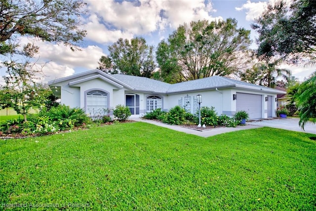 single story home with a garage and a front lawn