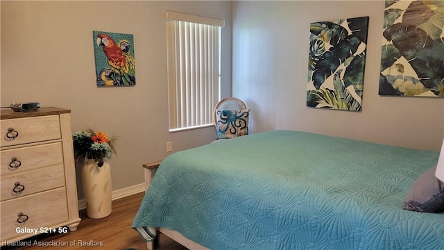 bedroom with wood-type flooring