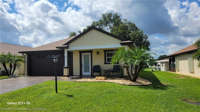 view of front facade featuring covered porch, a garage, and a front yard