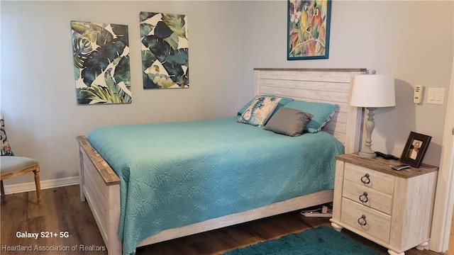 bedroom featuring dark hardwood / wood-style flooring