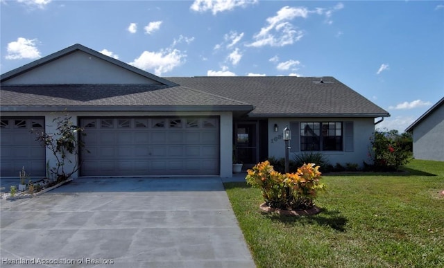 ranch-style home with a garage and a front lawn