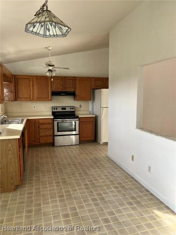 kitchen featuring ceiling fan, sink, hanging light fixtures, white refrigerator, and stainless steel electric range