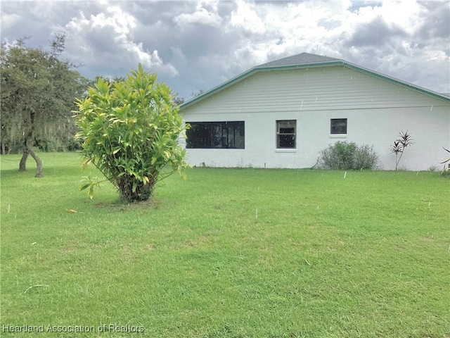 view of property exterior with a lawn