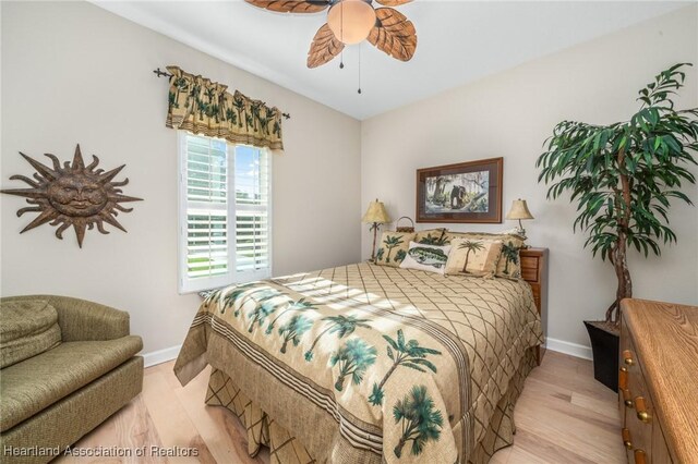 bedroom with ceiling fan and light hardwood / wood-style flooring