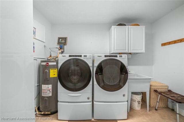 laundry area featuring independent washer and dryer, cabinets, electric water heater, and light tile patterned floors