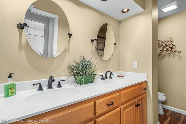 bathroom featuring hardwood / wood-style flooring, vanity, and toilet