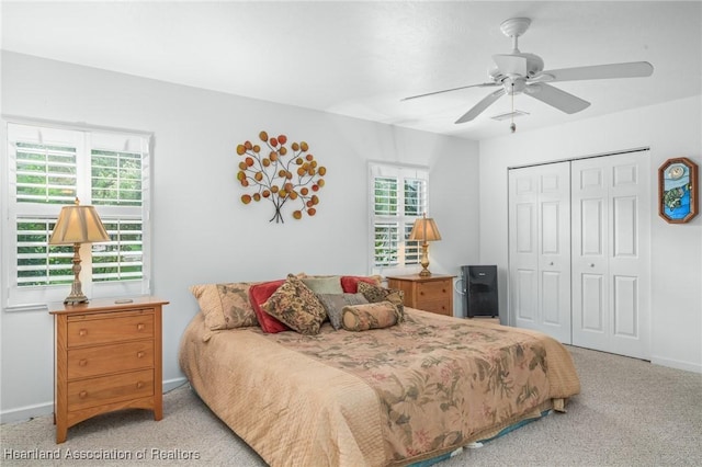 carpeted bedroom featuring ceiling fan and a closet