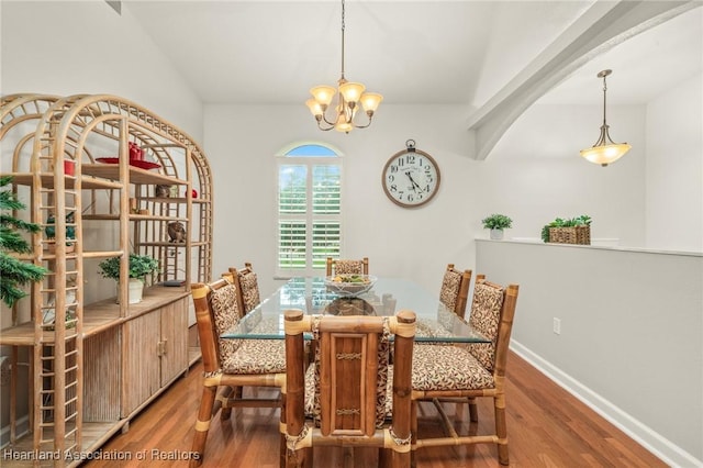 dining area featuring hardwood / wood-style flooring and a notable chandelier