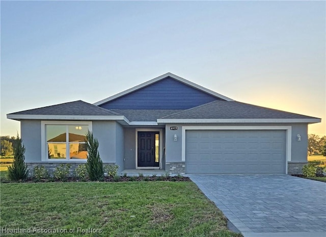 view of front of house with a lawn and a garage