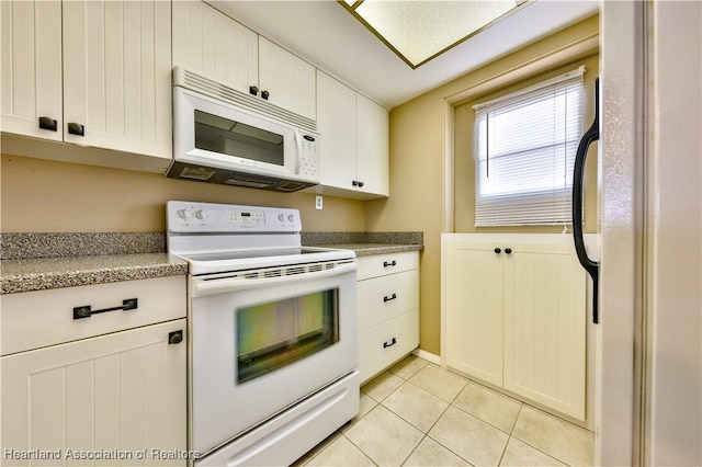 2131 Lakeview Dr Unit 508, Sebring, FL 33870 - kitchen with white appliances, light tile patterned floors, and white cabinetry
