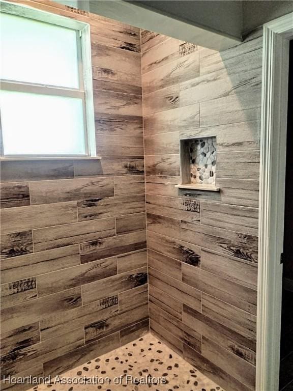 bathroom with a tile shower