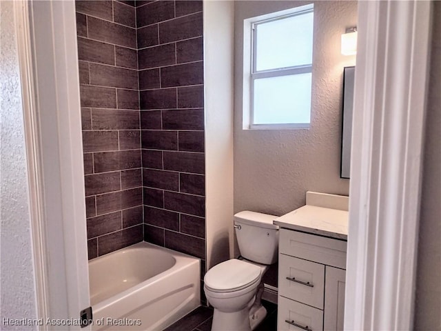 full bathroom featuring vanity, toilet, and tiled shower / bath combo