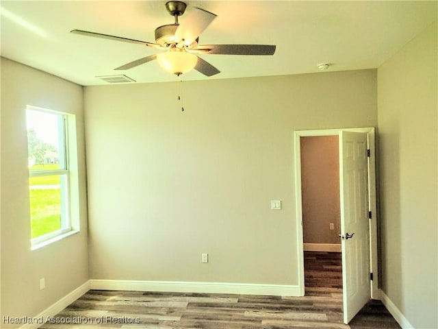 spare room featuring hardwood / wood-style flooring and ceiling fan