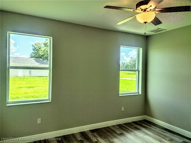 empty room with wood-type flooring and ceiling fan