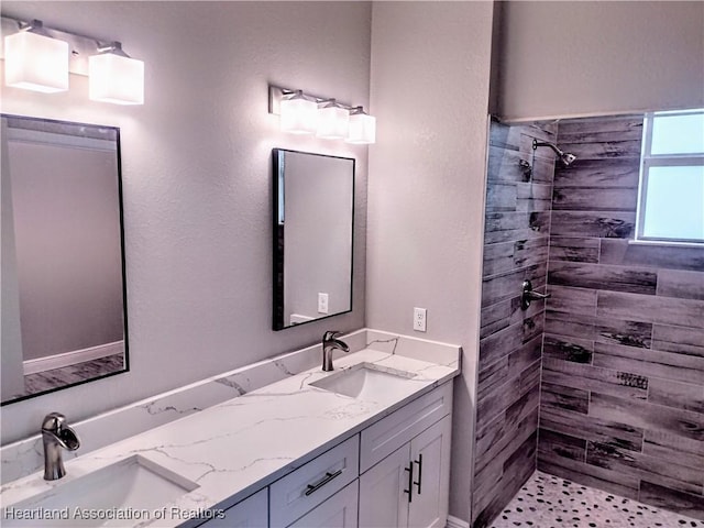 bathroom featuring vanity and tiled shower