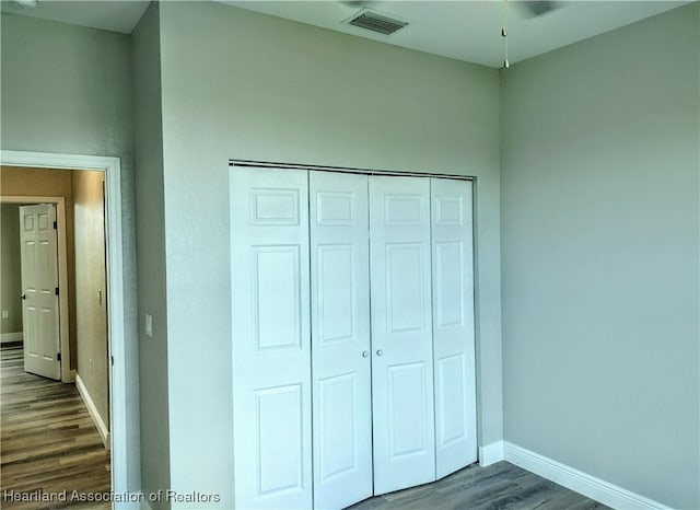 unfurnished bedroom featuring hardwood / wood-style flooring and a closet