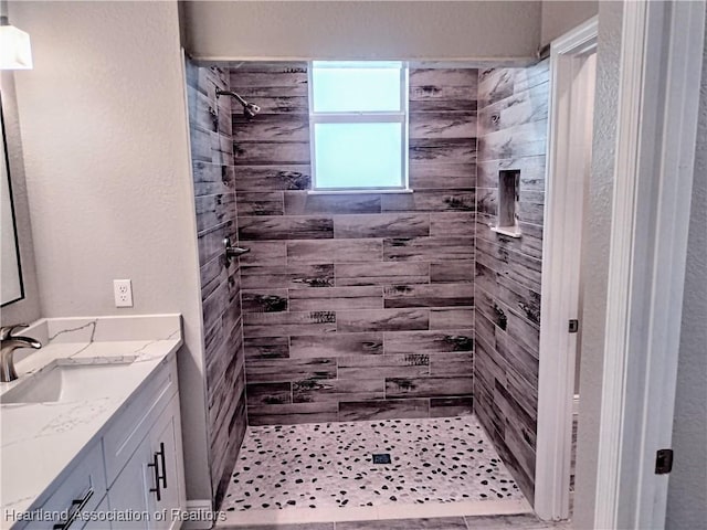 bathroom featuring vanity and a tile shower