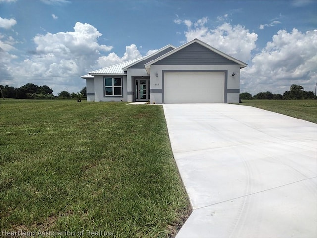 view of front of house with a front lawn and a garage