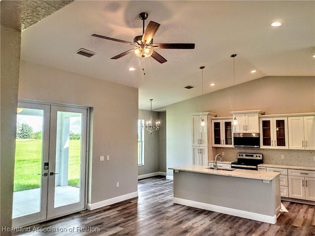 kitchen with french doors, backsplash, stainless steel appliances, sink, and white cabinets