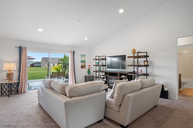 living room featuring high vaulted ceiling and light colored carpet