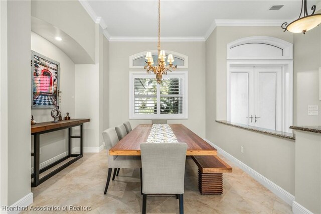 dining space featuring an inviting chandelier and crown molding