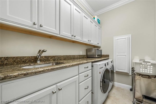 laundry area featuring light tile patterned floors, washing machine and clothes dryer, cabinets, ornamental molding, and sink