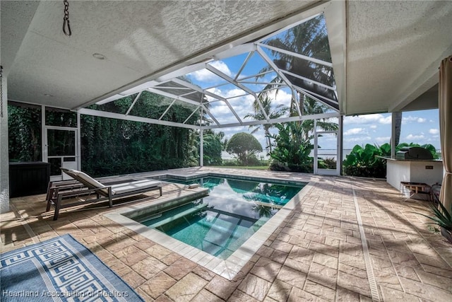 view of swimming pool featuring glass enclosure, a patio area, and an in ground hot tub