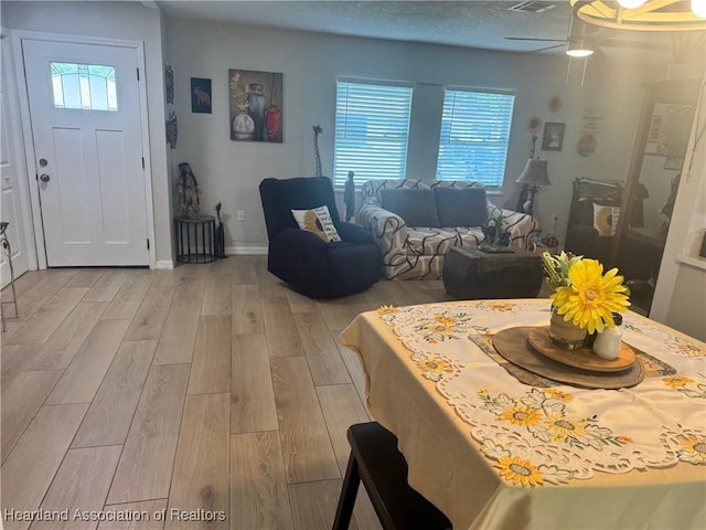4128 Capri St, Sebring, FL 33872 - dining space featuring a healthy amount of sunlight, baseboards, light wood-style flooring, and visible vents