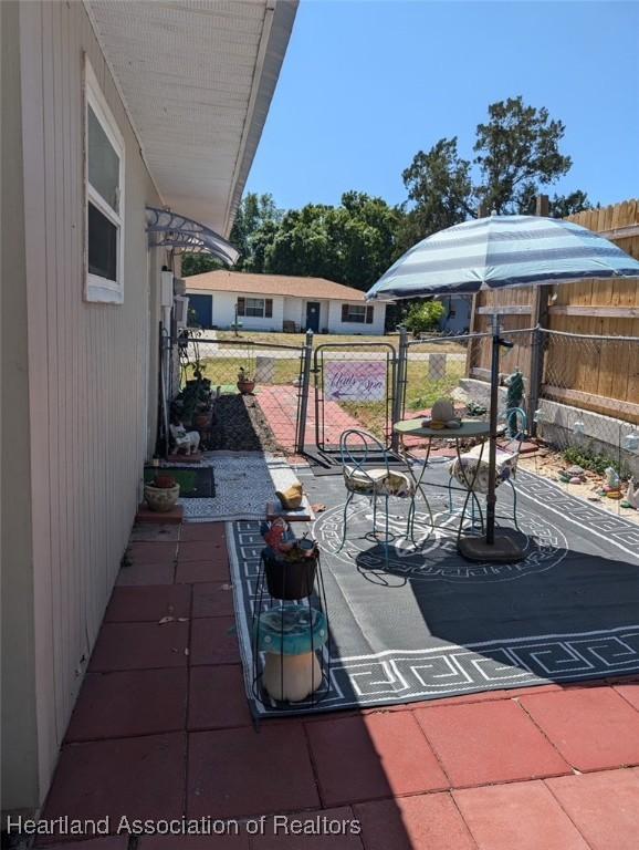 4128 Capri St, Sebring, FL 33872 - view of patio / terrace featuring fence and a gate