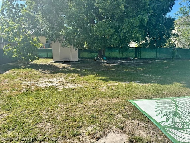 4128 Capri St, Sebring, FL 33872 - view of yard with an outdoor structure, a fenced backyard, and a storage shed