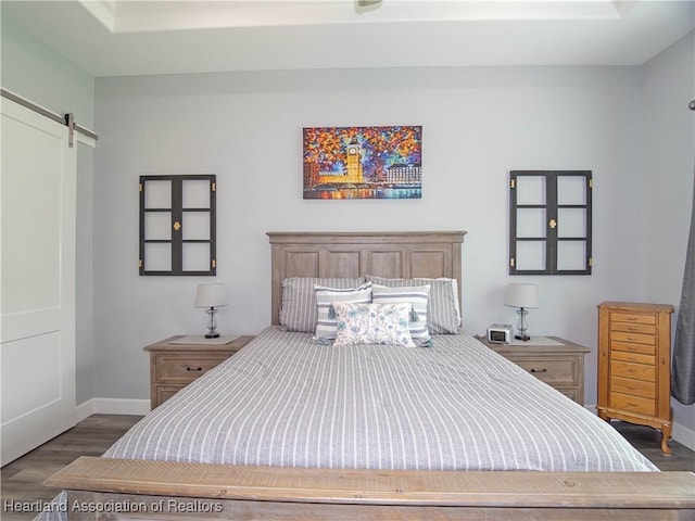 4936 Myrtle Dr, Sebring, FL 33872 - bedroom featuring dark wood-style flooring and a barn door
