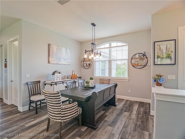 4936 Myrtle Dr, Sebring, FL 33872 - dining space featuring dark wood finished floors and a chandelier