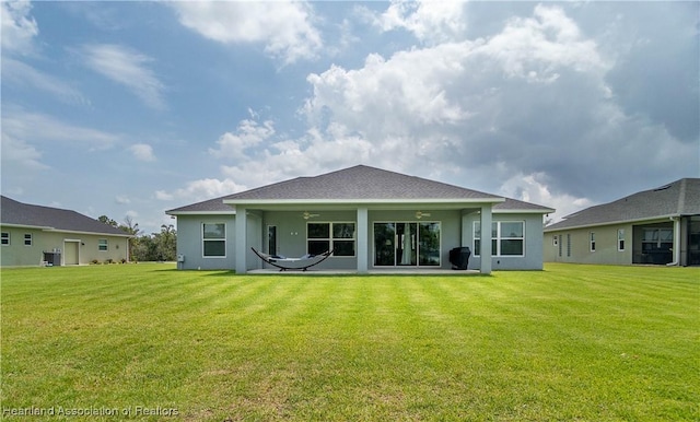 4936 Myrtle Dr, Sebring, FL 33872 - back of house featuring a ceiling fan, stucco siding, a lawn, and a patio