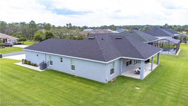 4936 Myrtle Dr, Sebring, FL 33872 - rear view of house featuring a shingled roof, a patio, a lawn, and a lanai