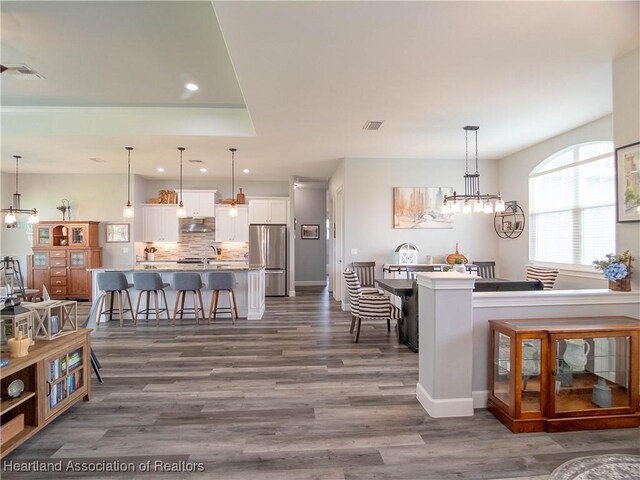 4936 Myrtle Dr, Sebring, FL 33872 - dining room featuring dark wood-style flooring, recessed lighting, and a chandelier