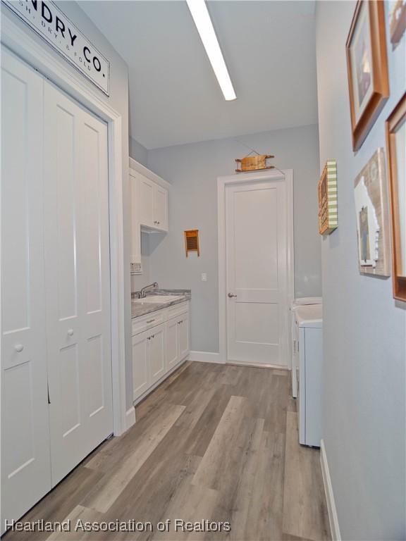 4936 Myrtle Dr, Sebring, FL 33872 - hall featuring light wood-style flooring and washing machine and dryer