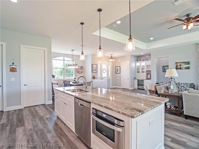 4936 Myrtle Dr, Sebring, FL 33872 - kitchen featuring stainless steel appliances, dark wood-style flooring, white cabinets, open floor plan, and recessed lighting
