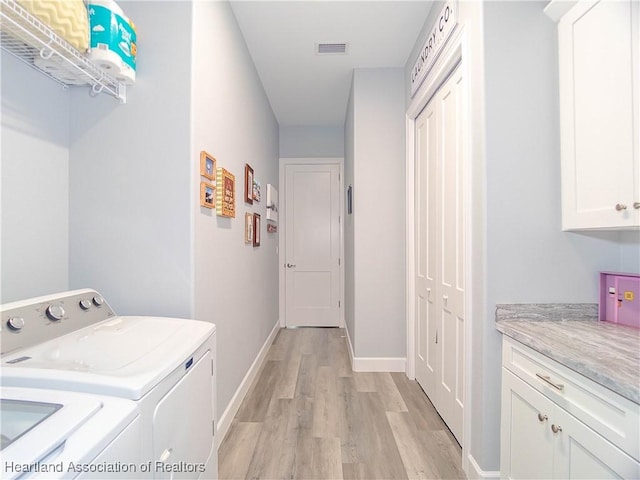 4936 Myrtle Dr, Sebring, FL 33872 - laundry room with separate washer and dryer, cabinet space, and light wood-style floors